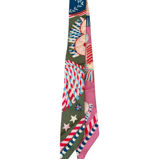 Knotted silk twill scarf featuring olive green and pink panels with candy cane, star, and festive stripe prints.