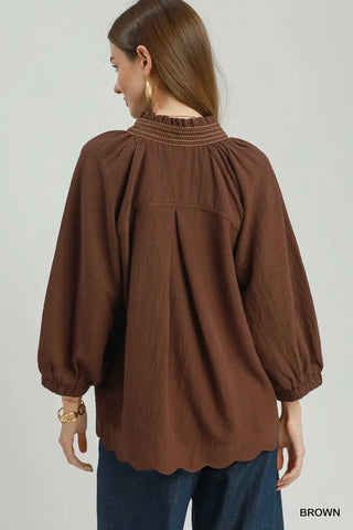 Brown scallop hem balloon sleeve blouse with ruffled mock neck and gathered back detail.