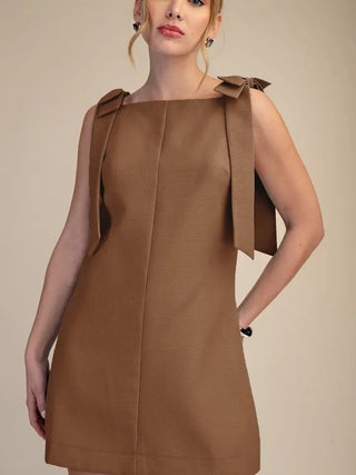 Camel brown textured mini dress with bow tie shoulder straps and A-line silhouette.