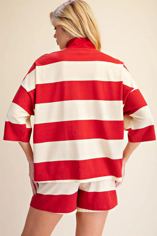 Red and cream wide-stripe oversized pullover top with zip neck and 3/4 sleeves, back view.