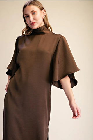 Chocolate brown satin midi dress with mock neck, flowy cape sleeves, and elegant drape detail.