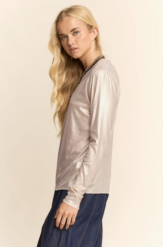 Metallic shimmer champagne long sleeve knit top with chain neckline detail, paired with dark denim.