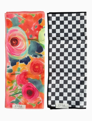 Two folded hand towels by Crae Home: one colorful floral print, one black and white checkered pattern.