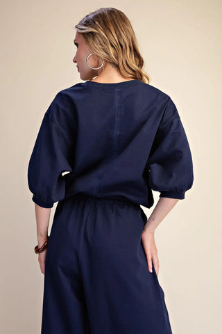 Navy blue pullover sweatshirt with puffed bubble sleeves and ribbed cuffs, shown from back view.