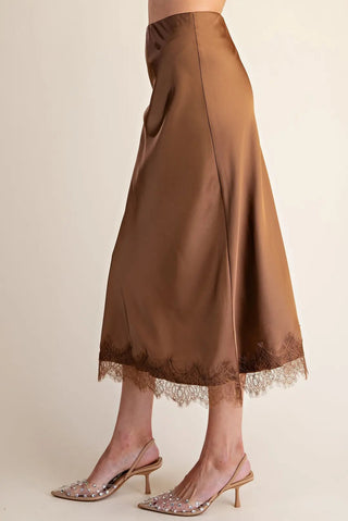 Brown satin midi skirt with matching lace trim hem, paired with embellished clear kitten heels.