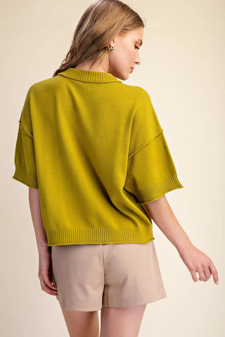 Olive green relaxed knit sweater with crew neck collar, elbow-length sleeves, and ribbed trim details.