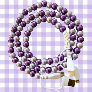 Purple and silver pearl-beaded charging cable with four connector tips on lavender gingham background.