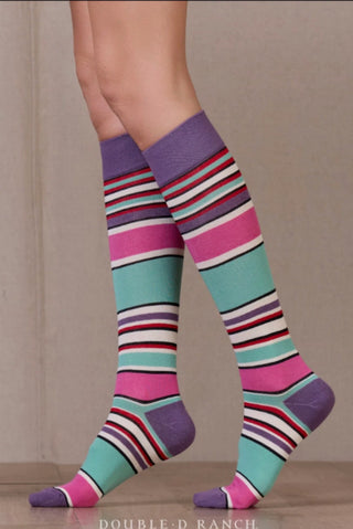 Knee-high striped serape socks in teal, pink, purple, red, and white with purple cuff and toe.