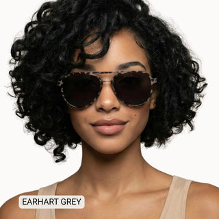Woman wearing Earhart Grey polarized aviator sunglasses with tortoise frames and dark grey lenses.