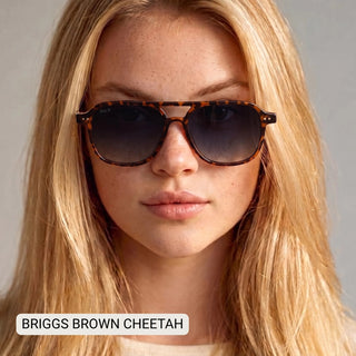 Woman wearing DAX Briggs polarized aviator sunglasses in brown cheetah tortoise print with gradient gray lenses.