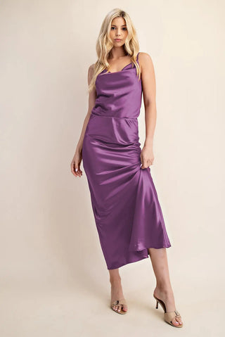 Purple satin midi skirt with elastic waistband and ruched side detail, styled with matching top.